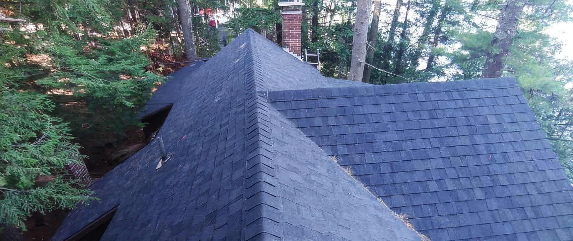 Pallets of IKO Cambridge and CertainTeed Landmark architectural shingles staged for a roofing job