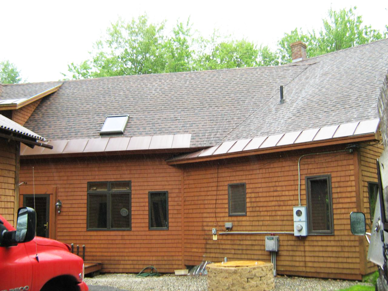 Standing seam metal roofing installation on log cabin